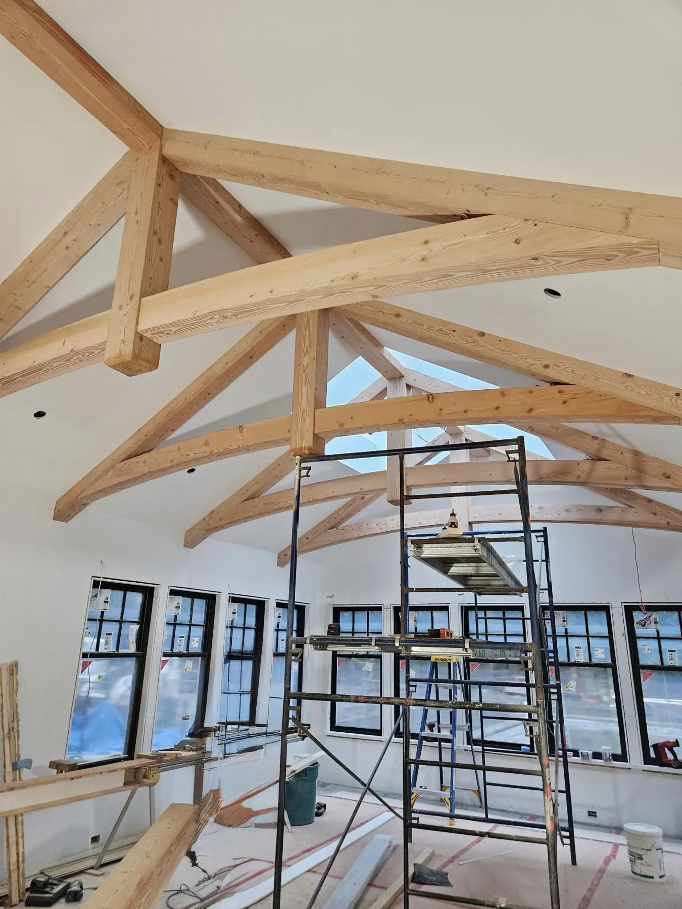 Renovated great room with finished trim, hardwood flooring and exposed beams