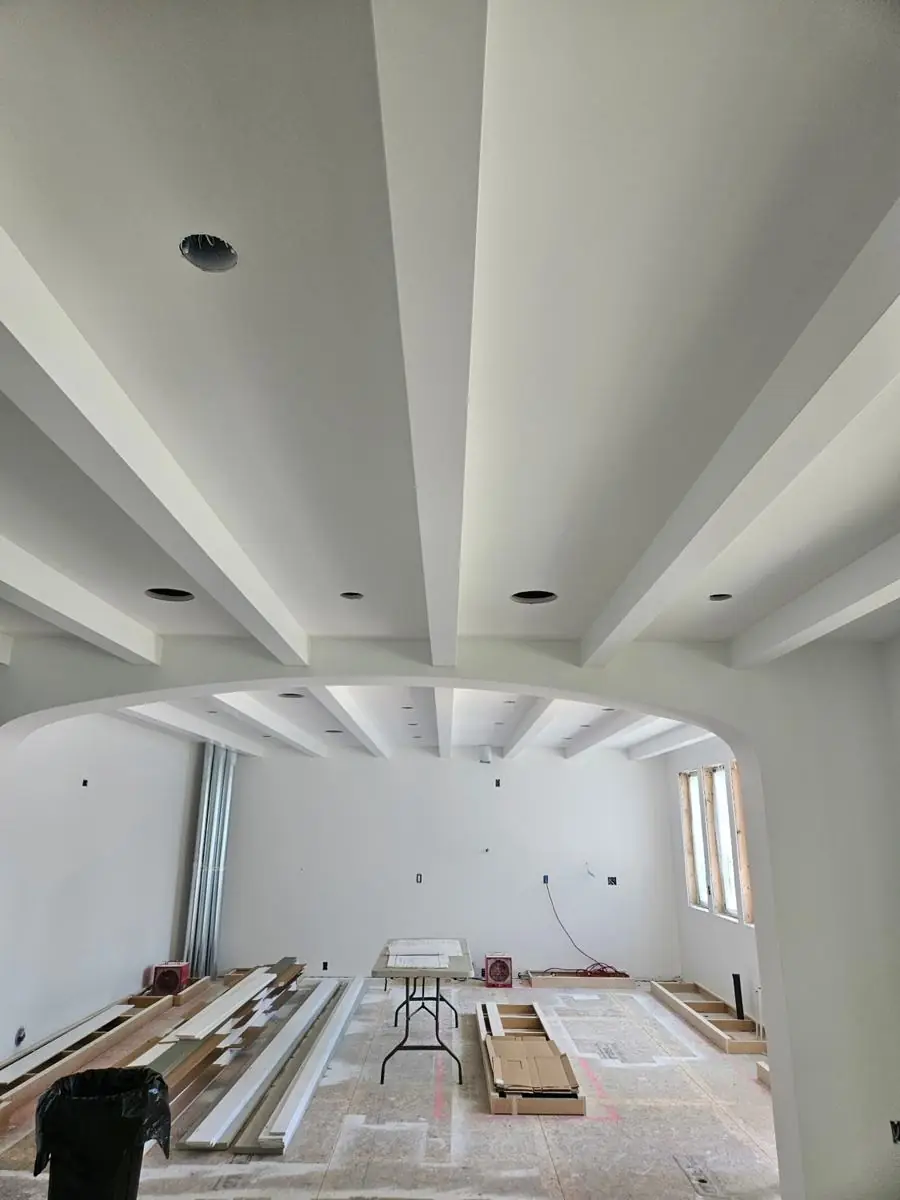 Beamed ceiling with arched opening and trim detail
