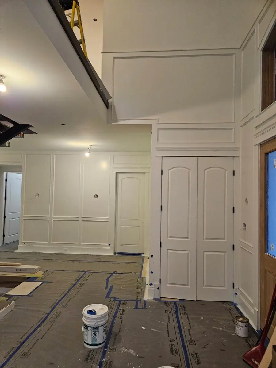 Raised-panel double doors with casing and wall panelling