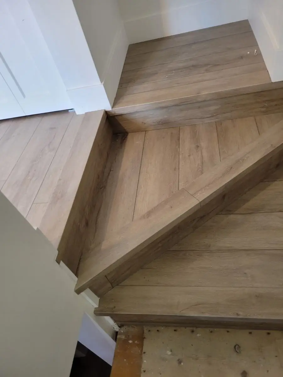 Wood-clad stair landing with treads and stringers